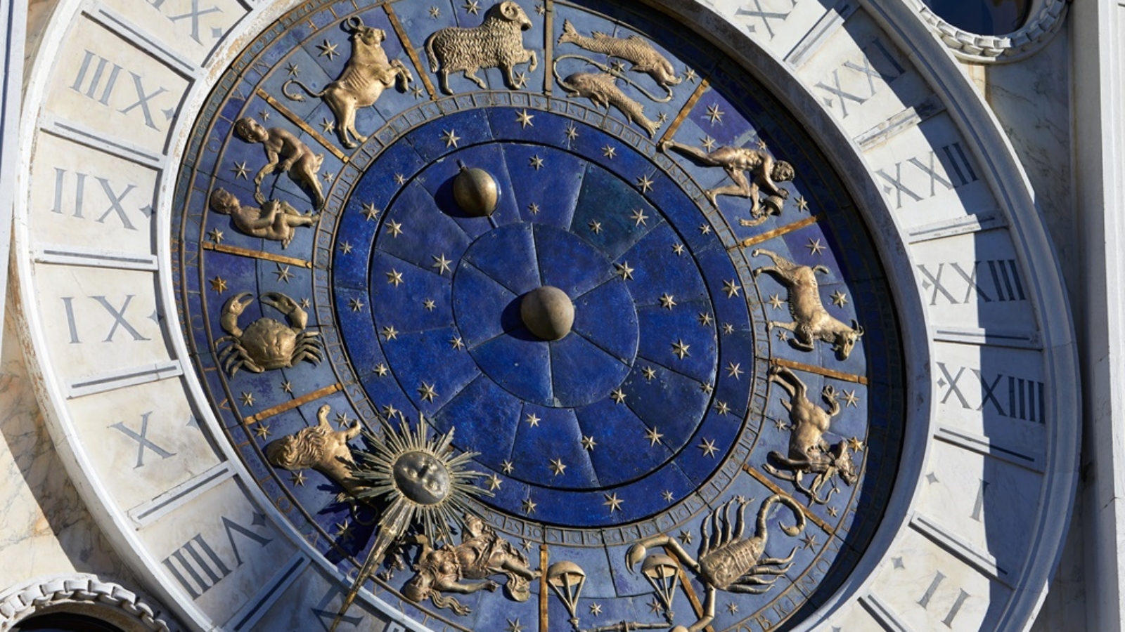 Golden zodiac astrological clock, sunlight and shadow